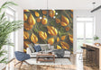 Golden leaf wallpaper mural creating a warm glow in a modern living room with gray sofa and natural light