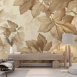 Large scale beige leaf wallpaper mural in a modern living room with natural light streaming through windows