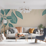 Teal leaf wallpaper mural creating a calm atmosphere in a modern living room with natural light
