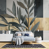 Botanical gold leaf wallpaper in modern living room, creating an elegant accent wall with soft grey and metallic details