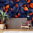 Navy blue and orange leaf wallpaper in modern living room with grey sofa and natural light