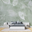 Botanical wallpaper in modern living room showing sage green leaf pattern creating depth