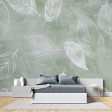 Botanical wallpaper in modern living room showing sage green leaf pattern creating depth