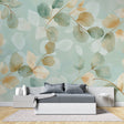 Mint and gold leaf wallpaper in modern living room creating fresh botanical atmosphere