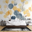 Modern living room with blue and gold watercolor leaf wallpaper creating a fresh, airy atmosphere