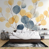 Modern living room with blue and gold watercolor leaf wallpaper creating a fresh, airy atmosphere