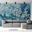 Blue watercolor leaf wallpaper creating a calm atmosphere in a modern living room with natural light