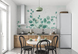Eucalyptus leaf wallpaper in a bright modern living room showing the scale of the botanical design