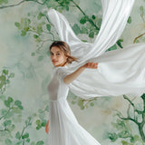 Botanical wall mural featuring green leaves in cozy bedroom setting