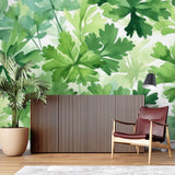 Botanical watercolor wallpaper in bright modern living room showing green leaf pattern