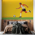 Football wall mural bringing sporty energy to a modern teen bedroom, showing dynamic player design against yellow background