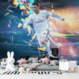 Football mural wallpaper styled in modern teen bedroom showing dynamic sports action