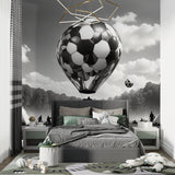 Football balloon wallpaper in modern teen bedroom showing black and white design with dramatic lighting