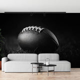Football wall mural in modern media room showing dramatic black and white photography design against gray couch