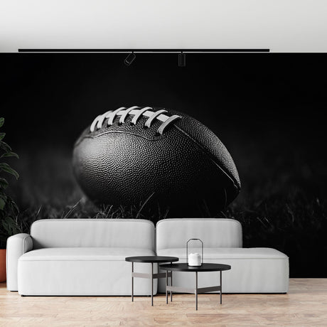 Football wall mural in modern media room showing dramatic black and white photography design against gray couch