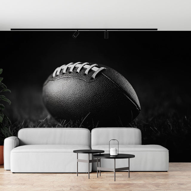 Football wall mural in modern media room showing dramatic black and white photography design against gray couch