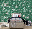 Football gaming wallpaper in modern teen bedroom showing pixel art design with gaming consoles and sports decor