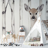 Woodland deer wallpaper bringing natural charm to a child's reading nook