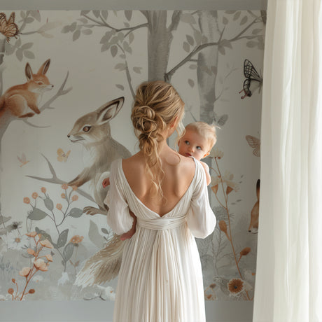 Forest animals wallpaper creating cozy atmosphere in modern nursery with white furniture and natural light