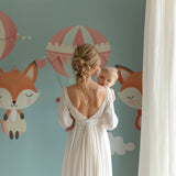 Forest Animals Wallpaper in cozy nursery with rocking chair and soft lighting, showing floating fox and pink balloons