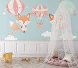 Kids room wall mural featuring fox and balloons, styled with white furniture and pink accents