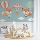 Hot air balloon wallpaper in toddler bedroom with play area and soft toys