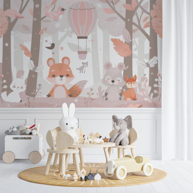 Forest Animals Wallpaper in a soft pink nursery with rocking chair and white furniture