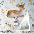 Forest animal wallpaper creating a cozy atmosphere in a white nursery with natural wood furniture