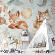 Forest animal wallpaper in cozy nursery with rocking chair and soft lighting showing sleeping fox design