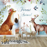 Whimsical fox and deer wallpaper adding magic to a baby's sleeping area