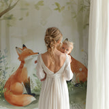 Woodland wallpaper brightening up a baby's room with soft natural lighting