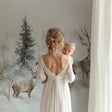 Forest deer wallpaper in a modern living room showing three majestic deer among misty pine trees