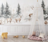 Woodland mural in reading nook showcasing deer among misty pine trees