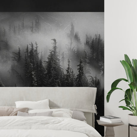 Black and white misty forest wallpaper in modern minimalist living room creating depth and atmosphere