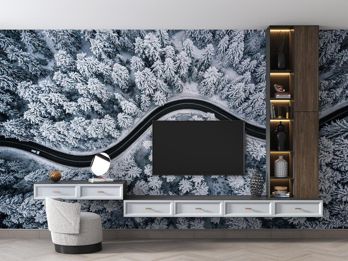 Winter forest wallpaper creating depth in a minimal bedroom, featuring aerial view of snow-covered pines