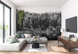 Black and white forest wallpaper creating depth in modern living room with minimal furniture