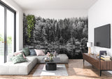 Black and white forest wallpaper creating depth in modern living room with minimal furniture