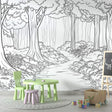 Black and white forest path wallpaper creating depth in a modern living room with minimal furniture