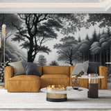Black and white forest wallpaper mural creating depth in a modern living room with minimal furniture