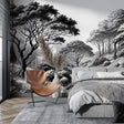 Black and white forest wallpaper creating depth in a modern living room with minimal furniture