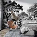 Black and white forest wallpaper creating depth in a modern living room with minimal furniture