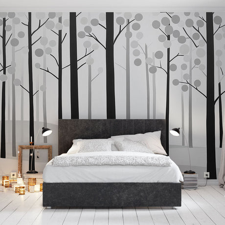 Black and white forest wallpaper creating depth in a modern Scandinavian living room with natural light