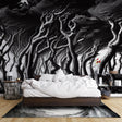 Black and white forest wallpaper creating depth in a modern living room with minimalist furniture