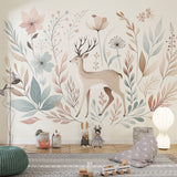 Forest deer wallpaper in a bright nursery with white furniture and soft pink accents