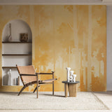 Golden forest wallpaper creating a warm glow in modern living room with minimal furniture