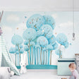 Blue forest wallpaper with butterflies creating a magical atmosphere in a modern nursery with white furniture
