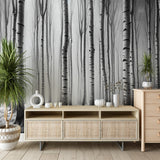 Black and white forest wallpaper creating a serene atmosphere in a modern living room with minimal furniture