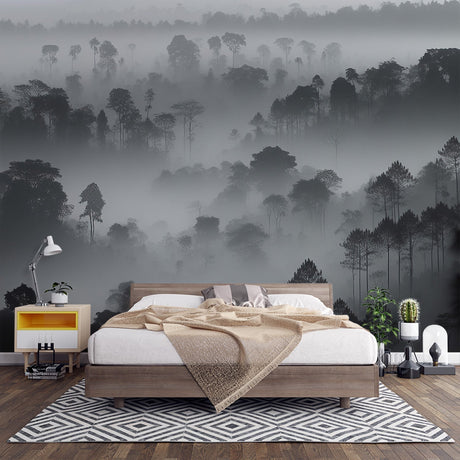 Misty forest wallpaper creating depth in a modern living room with black and white furniture