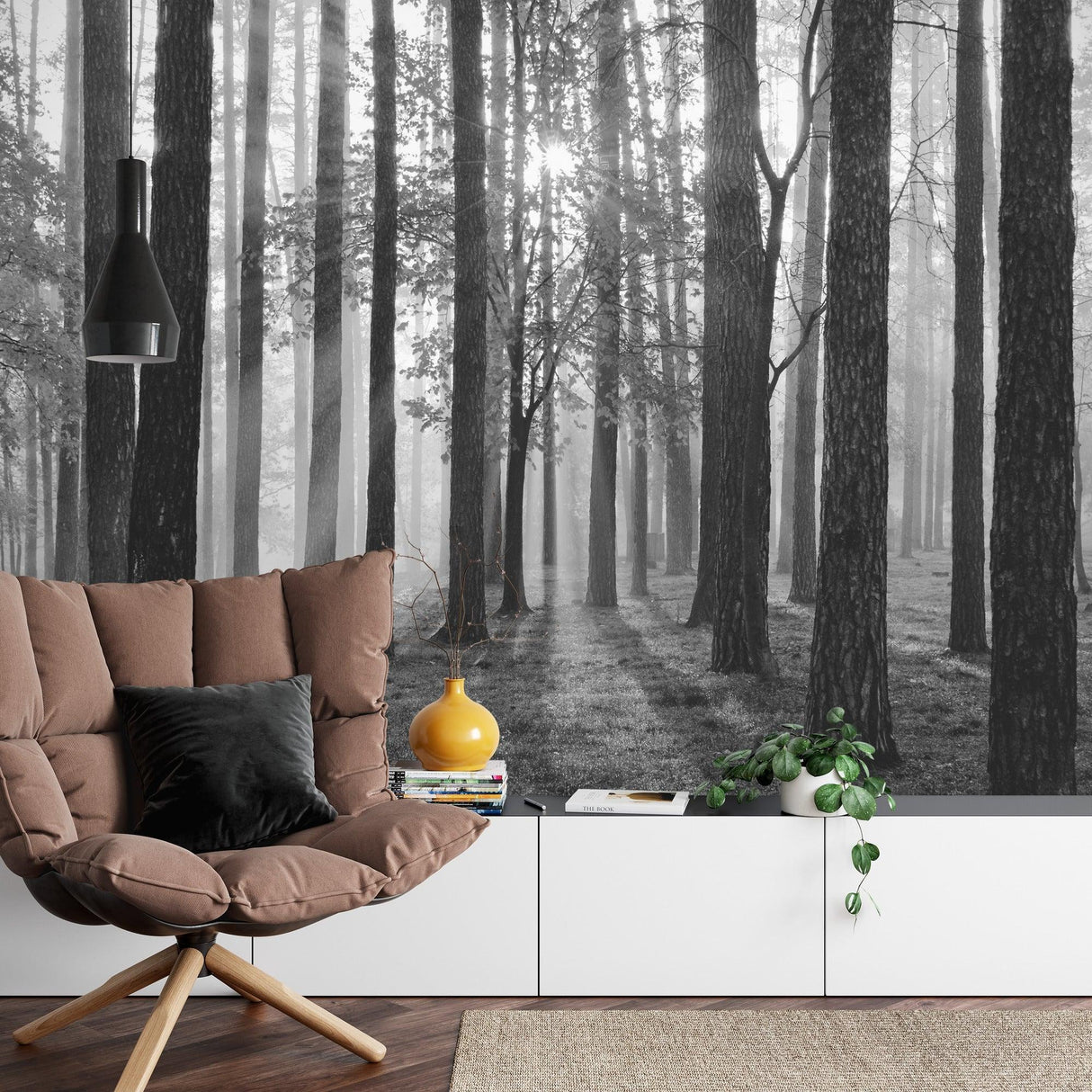 Black and white forest mural wallpaper creating depth in modern living room with minimal furniture