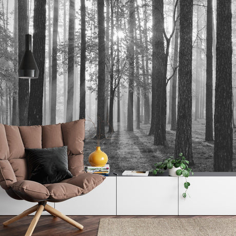 Black and white forest mural wallpaper creating depth in modern living room with minimal furniture